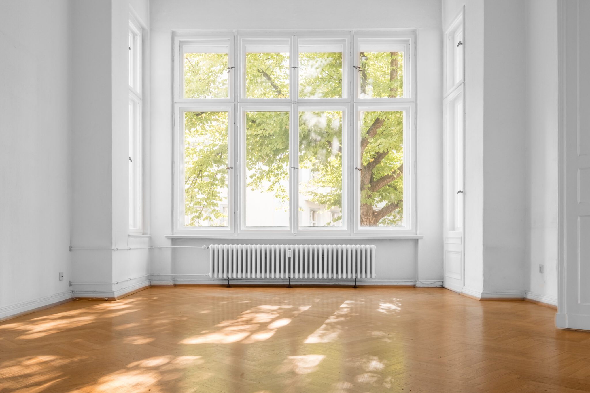 New living room window in bare living room with hardwood floors