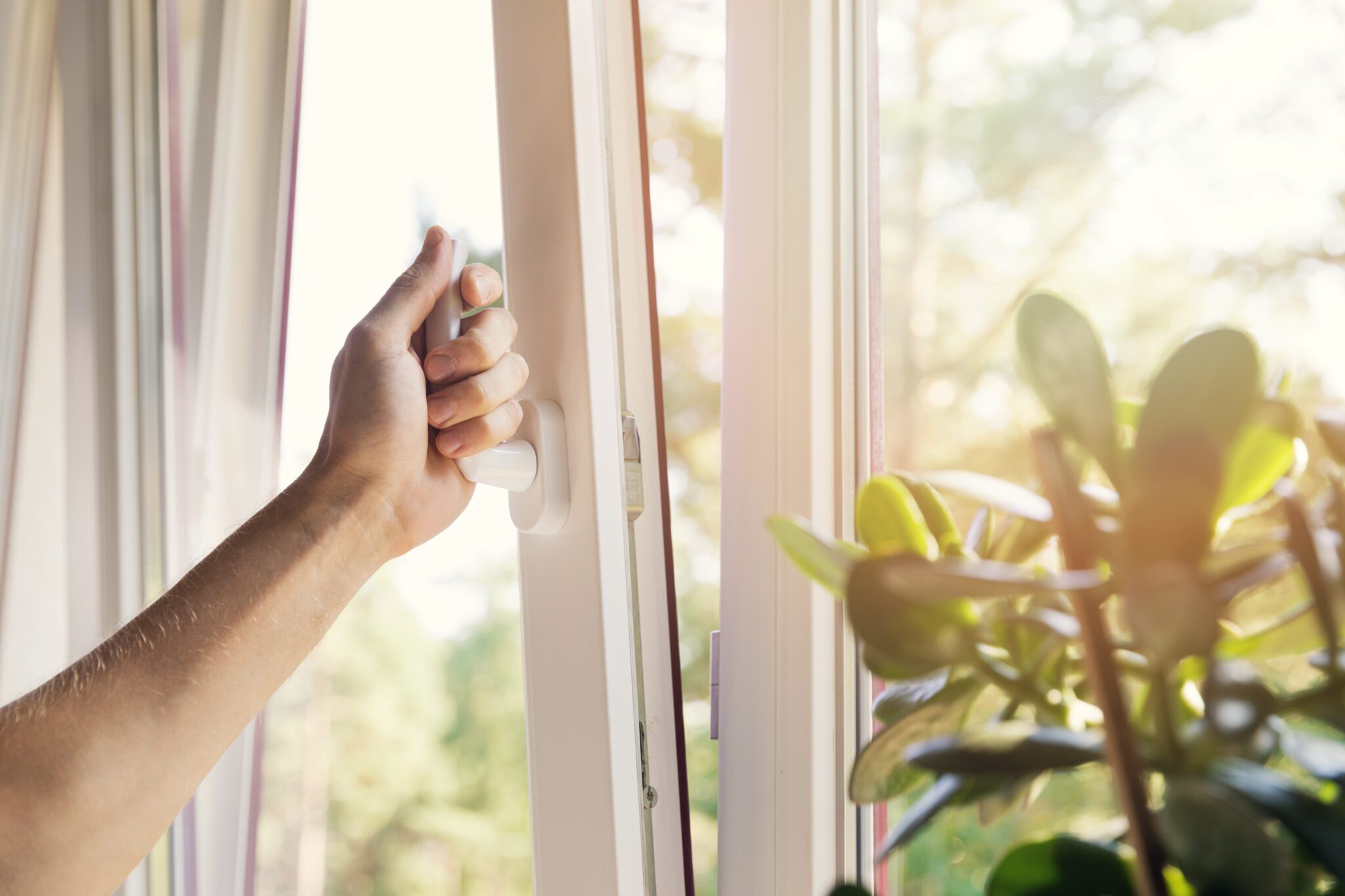 Closeup of opening window with handle