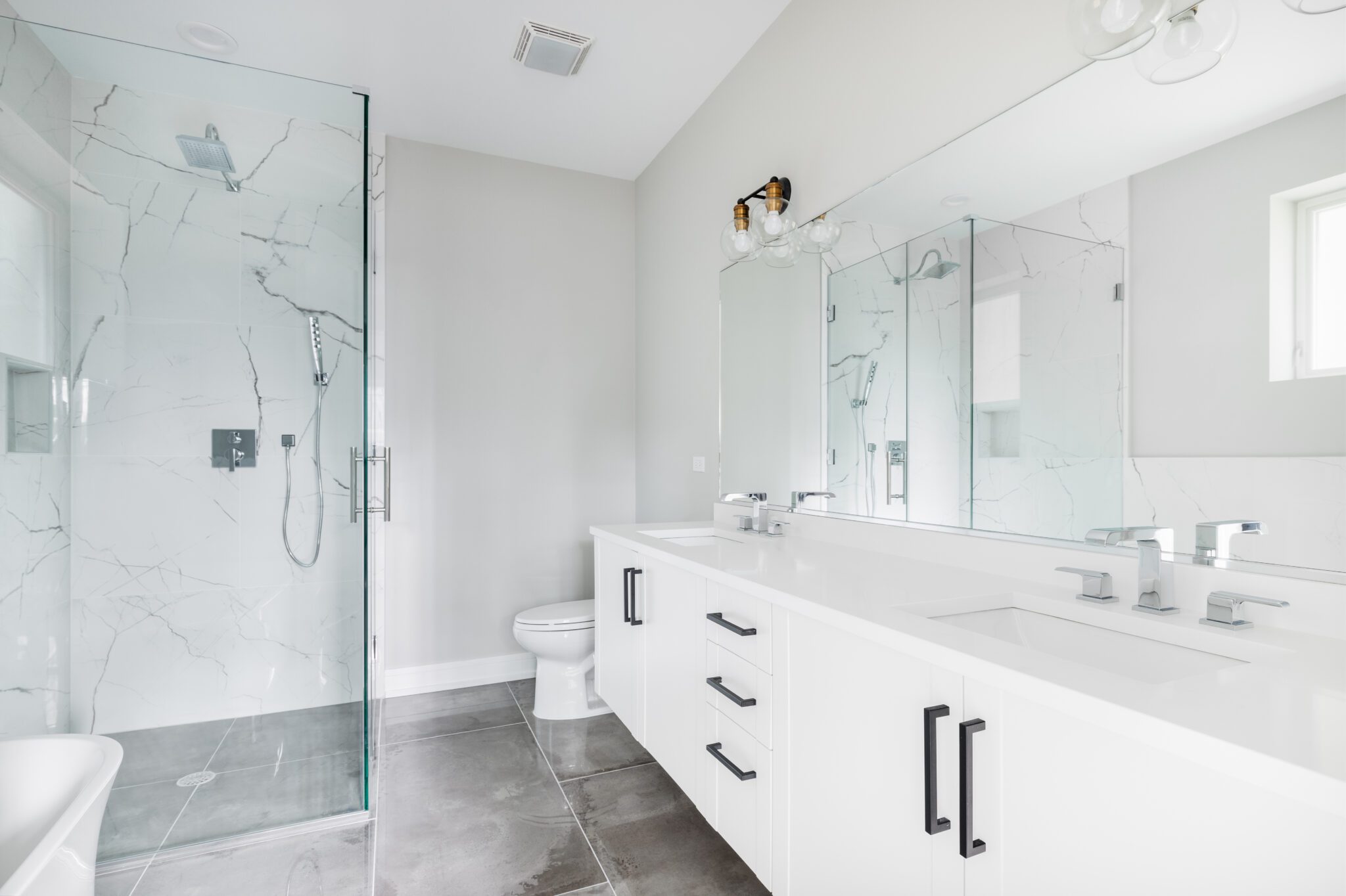 New shower glass with marble shower and gray floors
